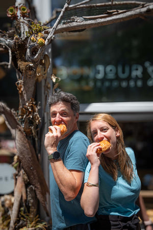 Ingrid and Francois, owner of Bonjour Bakehouse, eating croissants
