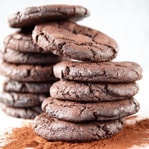 Dozen of cookies. Stack of 12 freshly baked Double Chocolate Cookies with powdered cocoa. Baked fresh daily in our San Francisco, California bakery with premium and organic ingredients.